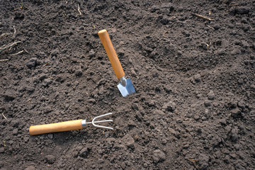 Garden tools on unpaved ground. Garden work. Spring garden concept.