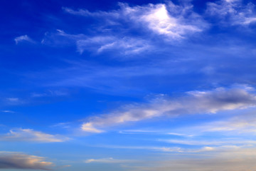 Beautiful picturesque unusual white feather clouds in the blue sky, magic background. А fantastic white clouds. Landscape background, climate change, global warming
