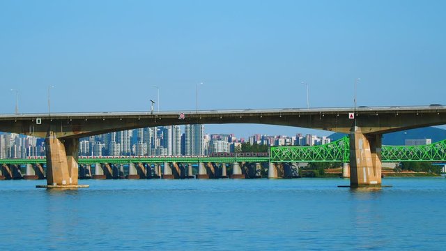Shot of trains moving through the bridge across Han River in Seoul, South Korea