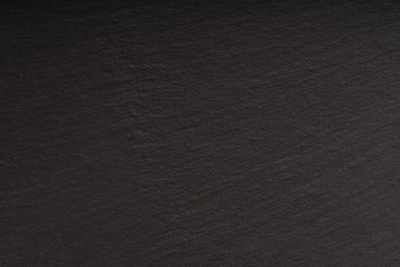 Smooth polished black stone surface, top view