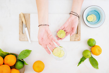 Citrus infused water preparation. Fresh oranges and limes