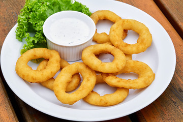 A onion rings on a plate on a table