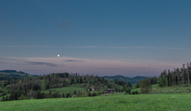 Before sunrise with moon and pasture land near Valasska Polanka village