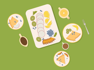 A set of useful food consisting of exotic berries and fruits on the plates are beautifully laid out. pitahaya, oranges, blueberries and kiwi with pancakes.