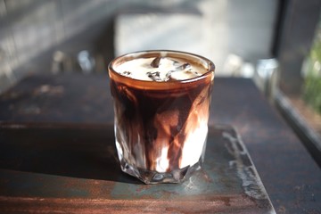 The expresso with chocolate and  milk in a cup