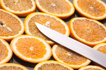 Fototapeta na wymiar sliced pieces of textured orange and knife-edge glitters