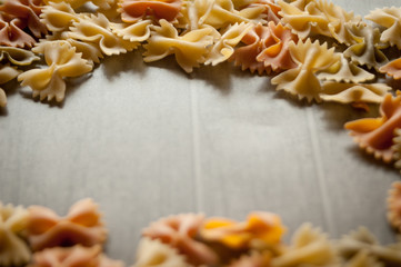 bow tie pasta frame on gray background