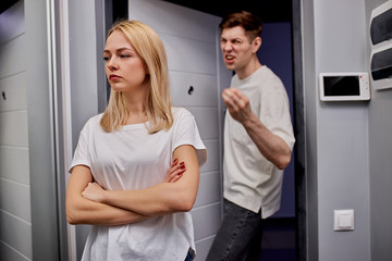 man is tired of his wife, he wants to get a divorce. man is standing at the threshold near the...