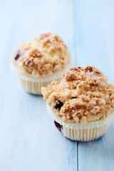 Blueberry Muffins on bright wooden background. Close up. 
