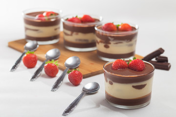 Chocolate dessert with layered mascarpone, decorated with strawberries.