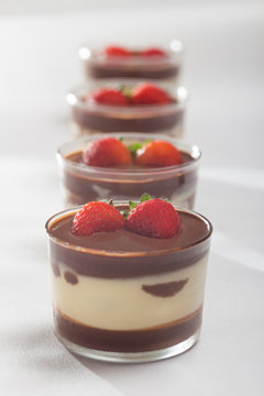 Chocolate dessert with layered mascarpone, decorated with strawberries.