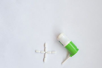 pills and throat spray on a white background