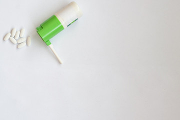 pills and throat spray on a white background