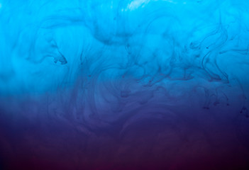 Abstract blue background. Liquid background with floating blue paint in a water. Psychedelic and art concept