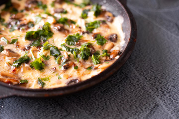 authentic omelet with mushroom champignons in a pan standing on the stove, delicious nutritious breakfast,