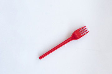 red disposable forks on a white background