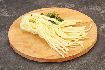 Chechil spaghetti cheese over board