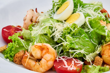 A plate of shrimp caesar salad on white plate