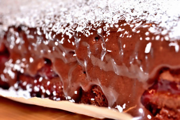 Texture of baked gingerbreads with strawberry jam, sprinkled coconut and chocolate cream. Macro detail.