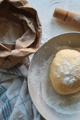 Knead dough from flour on the wooden table. Preparing the dough for baking. Cooking homemade cuisine for family. Chef workplace in kitchen. Making pastry. Healthy delicious culinary recipe