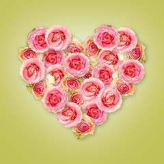 Bouquet of tea roses in the shape of a heart on a light green background. Valentine's Day.