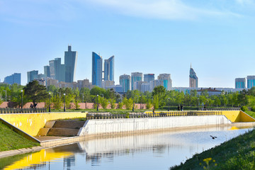 Astana embankment, embankment, view of Astana, Yesil, Ishim, lights, buildings, spring, summer, green city, Astana city, on a river,