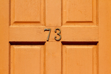 A London front door with the house number 73