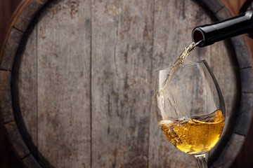 pouring white wine in glass