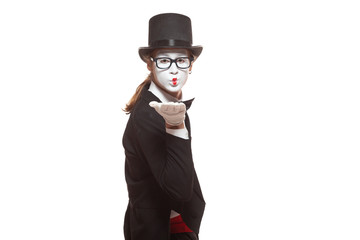 Portrait of male mime artist performing, isolated on white background. Mime blows a kiss. Symbol of sympathy, love, relationships