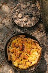 chelsea bun baked in the Dutch Oven with preaheated charcoal briquettes,, outdoor cooking, campfire dessert