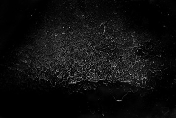 White scratches and dust on black background. Old dirty glass.