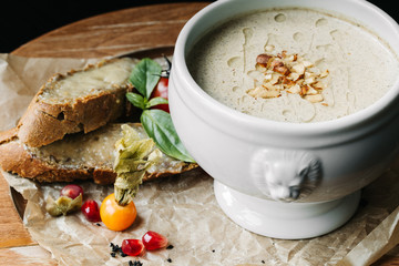 A plate of cheese soup and a cup of coffee