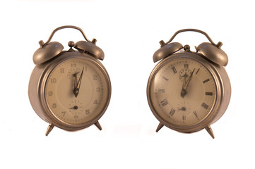 Two old clocks on a white background