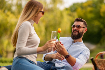 Happy young couple enjoying a day in summer park together