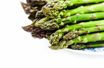 Bunch of fresh raw asparagus on white background, vegetarian concept. Green grass sparrowgrass sticks, food for veggie.