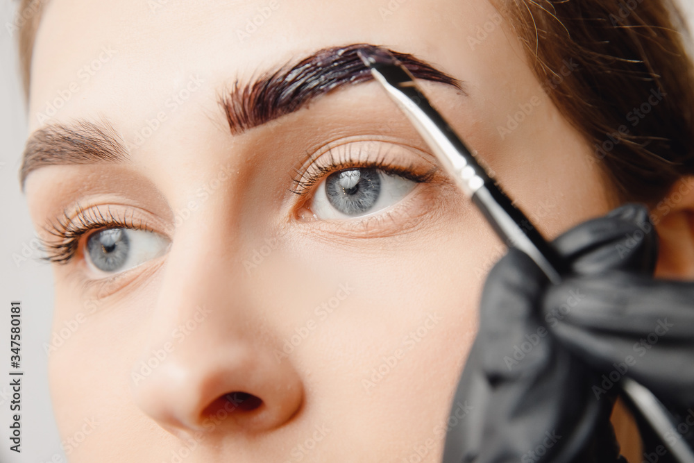Henna brow tinting in beauty salon (Adobe Stock comp)