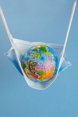 Earth globe in medicine mask to fight against Corona virus - 347580572