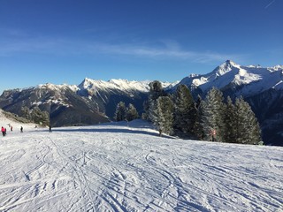 Ski run with Snow covered Mountains in the background 
