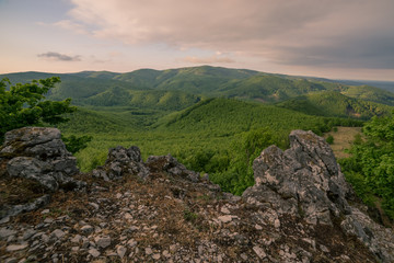 From the rock at the top of the mountain there is a view of the green mountain landscape of the national park