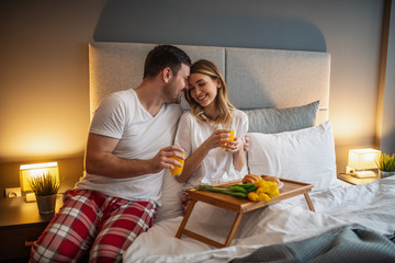 Portrait of happy couple in bedroom