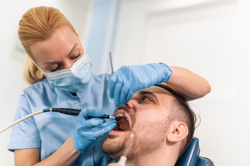 Obraz na płótnie Canvas Dentist and patient in dentist office