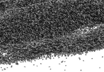 A pile of Poppy seeds spread on a white background