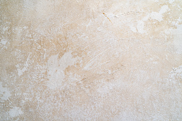 Light beige texture of the wall with scuffs and smears of plaster. Background