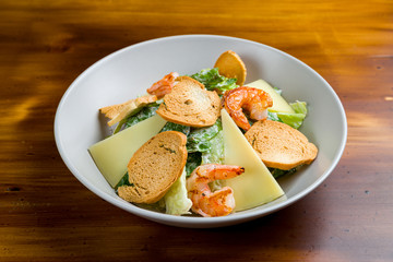 salad caesar with shrimps on white plate