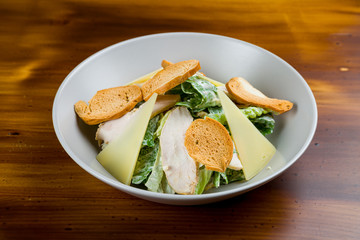 Salad caesar with chicken on white plate