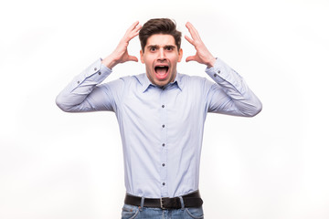Young man screaming mouth open, hold head hand, wear casual blue shirt, isolated white background.