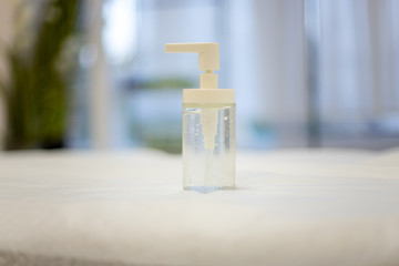 Antibacterial agent against viruses and bacteria. The bottle contains a disinfectant liquid. Against the background inside the hospital.