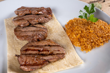 Grilled lamb chops. Fresh grilled steak on black background. Close up of steak kebab and top view.