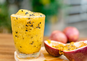 Passion fruit smoothie in a glass on wood table and nature background, Refreshing to thirsty drink in summer, Good food high vitamin C, Nourishing the eyes, Relieve constipation. Rich in antioxidants.