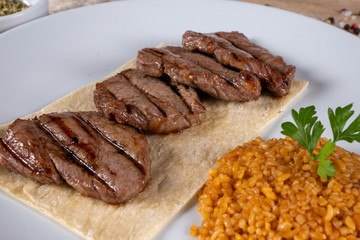 Grilled lamb chops. Fresh grilled steak on black background. Close up of steak kebab and top view.